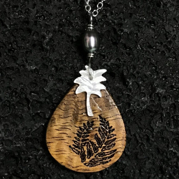 Koa Wood Teardrop Shaped Fern Engraved Pendant with Palm Tree Shaped Carved Shell Pendant and Dark Pearl Necklace